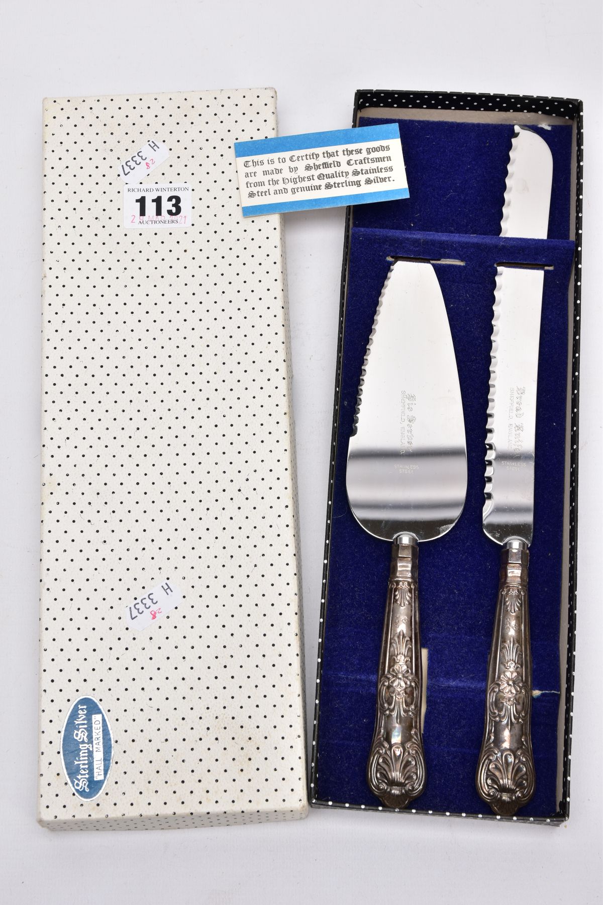 A STAINLESS STEEL AND SILVER HANDLED TWO PIECE SET, to include a bread knife and pie server, each