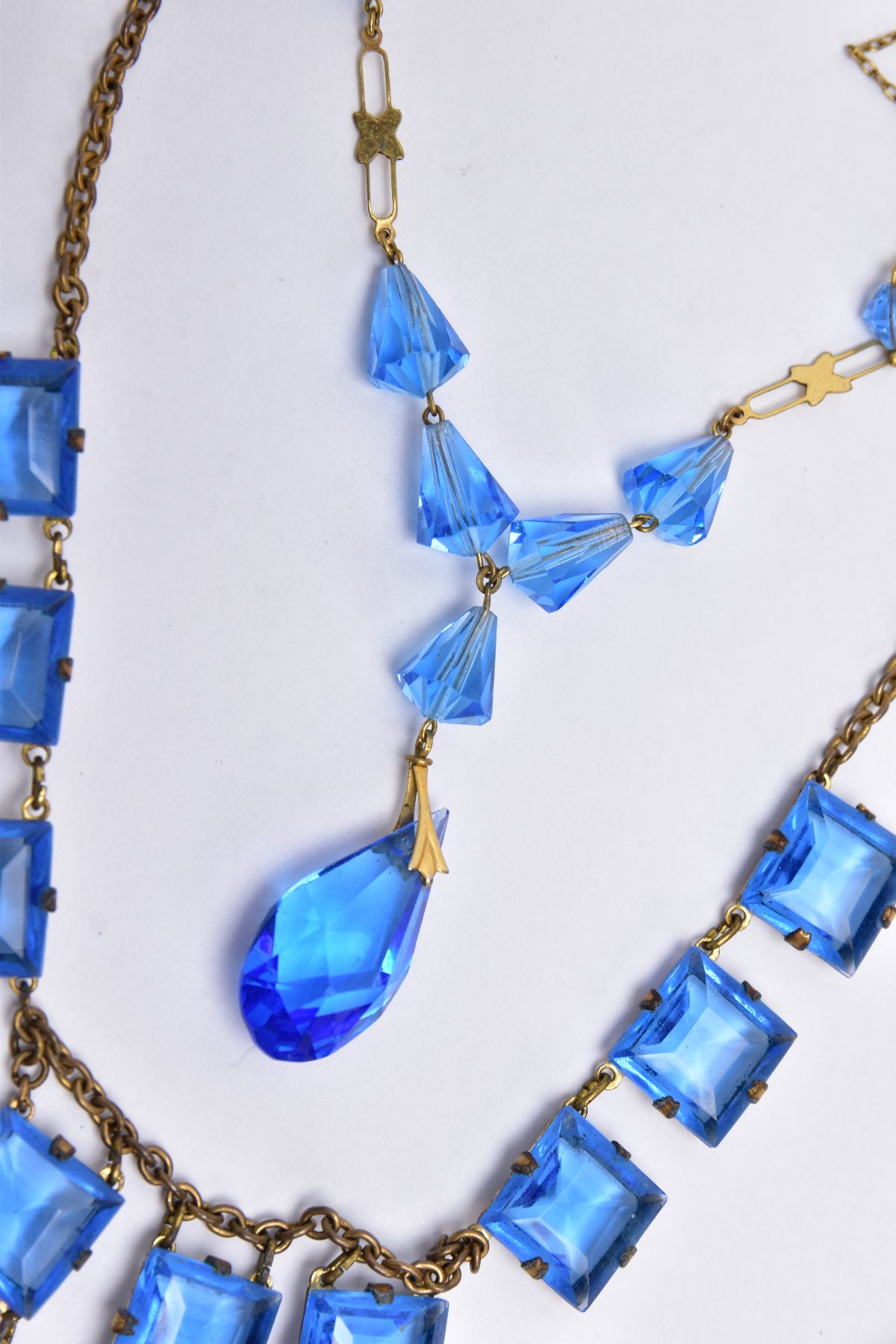 TWO BLUE PASTE SET NECKLACES, the first set with square blue paste on a brass toned curb link chain, - Image 3 of 3