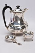 A GEORGE V SILVER HOT WATER JUG OF LOBED OVAL FORM, ebonised fitments, engraved initial, on four