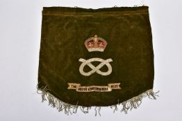 A 60CM X 53CM VELVET AND MATERIAL BACKED MILITARY DISPLAY BANNER, featuring the Regimental crest