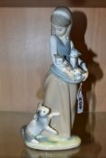 A LLADRO FIGURE GROUP 'FOLLOWING HER CATS', No.1309, designed by Juan Huerta 1974, retired 2005,