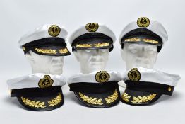 A BOX CONTAINING SIX IMITATION ROYAL NAVY STYLE OFFICERS CAPS, the type mainly sold at seaside/