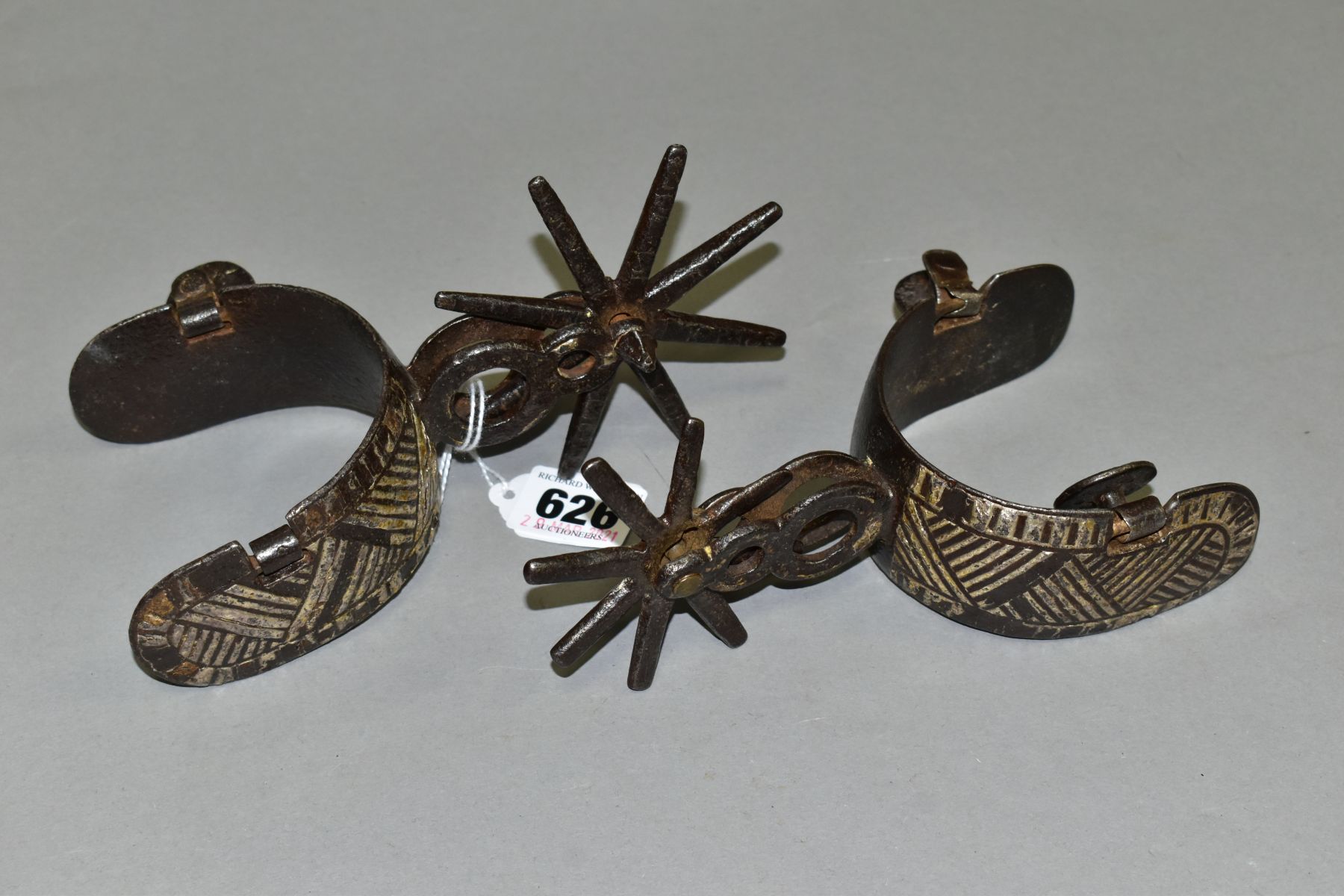 A PAIR OF SOUTH AMERICAN SILVER OVERLAID GAUCHO SPURS (2)