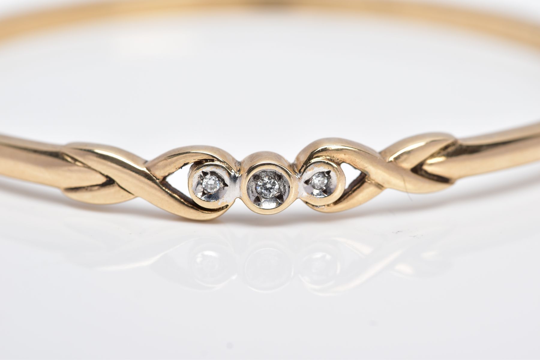 A 9CT GOLD DIAMOND BANGLE, designed with a crossover section set with three round brilliant cut - Image 5 of 5