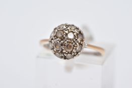 AN 18CT GOLD CLUSTER RING, the domed cluster set with circular cut colourless stones assessed as