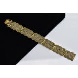 A SILVER GILT MARCASITE WIDE LINK BRACELET, designed with six wavy edge textured links, set with