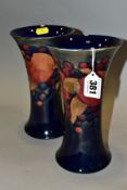 A NEAR PAIR OF WILLIAM MOORCROFT POMEGRANATE PATTERN TRUMPET SHAPED VASES, flared rims and bases,