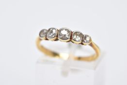 A YELLOW METAL DIAMOND RING, designed with a row of graduated old cushion cut diamonds, each