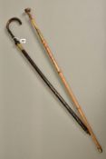 TWO ANTIQUES SWORD STICKS, the one has a carved bone handle and its oblong shaped blade is marked