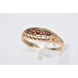 A 9CT GOLD FIVE STONE RING, designed with a row of five circular cut garnets, within an openwork