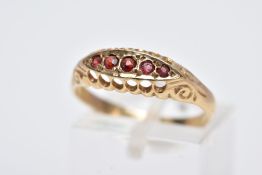 A 9CT GOLD FIVE STONE RING, designed with a row of five circular cut garnets, within an openwork