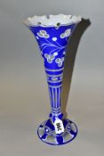 A LATE 19TH CENTURY BOHEMIAN GLASS TRUMPET SHAPED VASE, crenellated rim above blue and white cut
