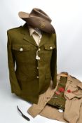 A MODERN BRITISH ARMY UNIFORM JACKET, TROUSERS AND TWO SHIRTS on hangers with suit protection bag,