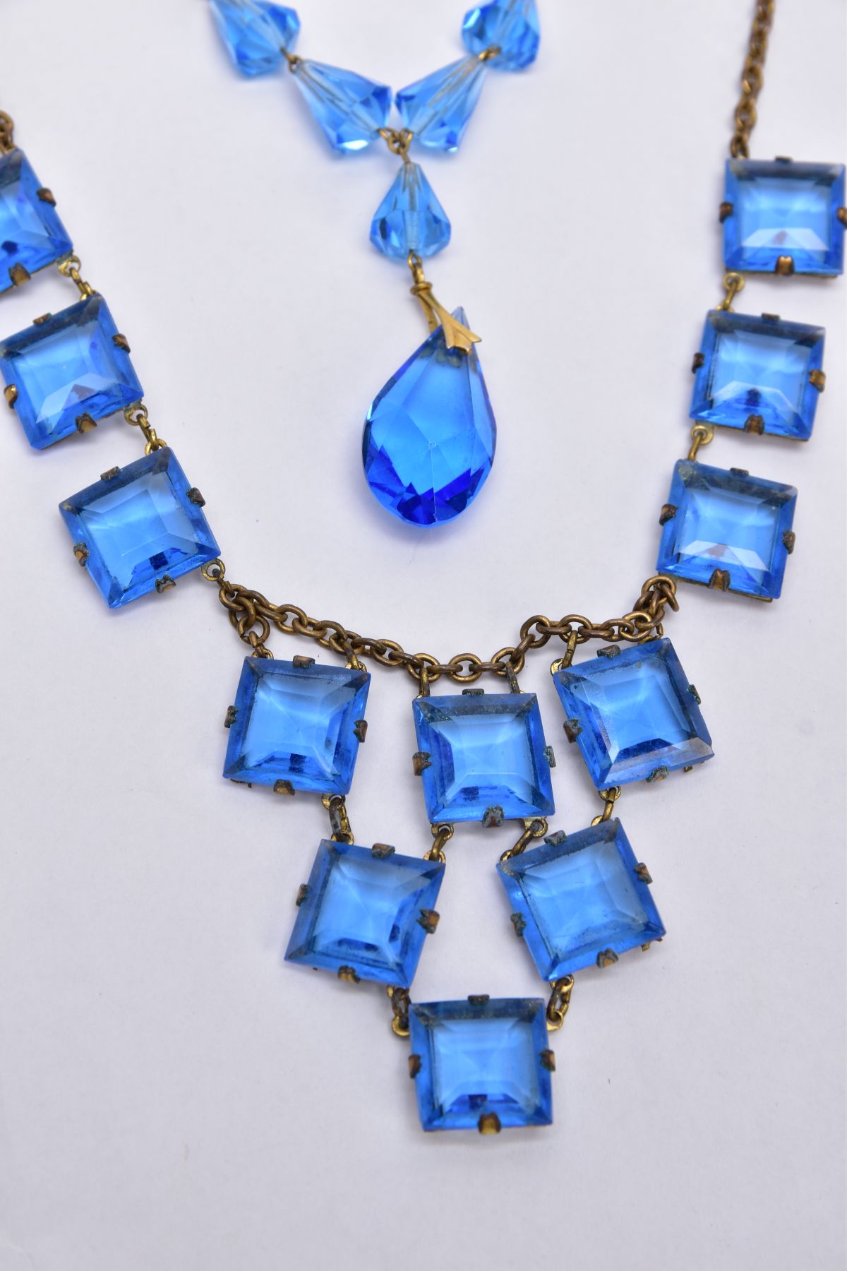 TWO BLUE PASTE SET NECKLACES, the first set with square blue paste on a brass toned curb link chain, - Image 2 of 3