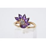 A 9CT GOLD AMETHYST AND DIAMOND RING, designed with a spray of six marquise cut amethysts with a