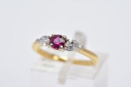 AN 18CT GOLD RUBY AND DIAMOND RING, designed with a central claw set, circular cut ruby, flanked