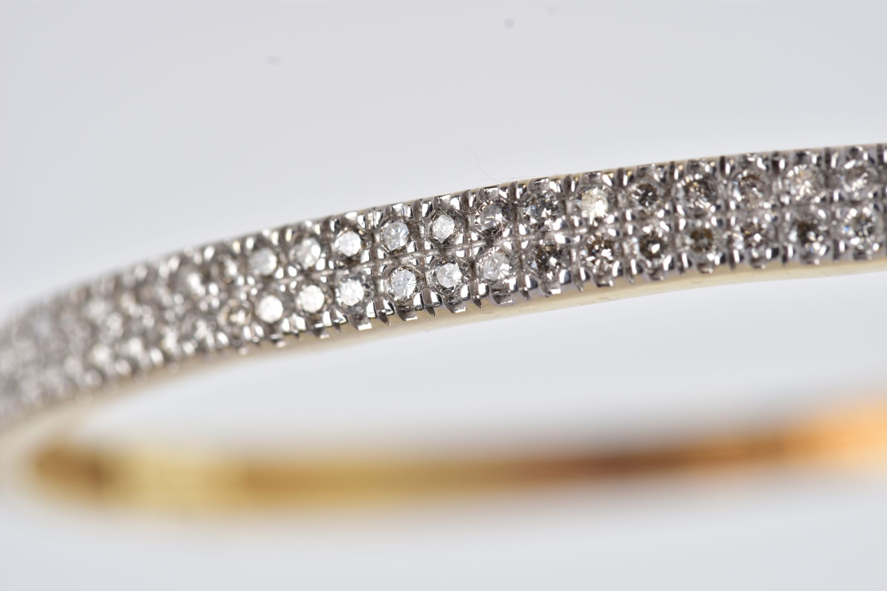 A YELLOW METAL DIAMOND BANGLE, the hinged bangle designed with two rows of round brilliant cut - Image 6 of 6
