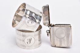 TWO SILVER NAPKIN RINGS AND A SILVER VESTA, each napkin ring of a circular form, engine turn