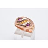 AN EARLY TWENTIETH CENTURY 9CT ROSE GOLD DOUBLE SNAKE HEAD RING, set with diamonds, a ruby and an