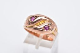 AN EARLY TWENTIETH CENTURY 9CT ROSE GOLD DOUBLE SNAKE HEAD RING, set with diamonds, a ruby and an