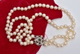 A CULTURED PEARL NECKLET, two strands of cultured pearls, individually knotted on a white cord, each