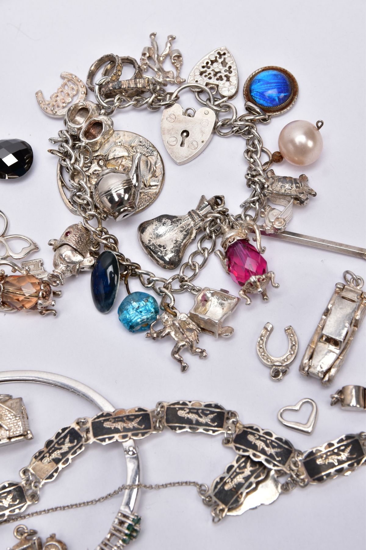 A BAG OF ASSORTED JEWELLERY, to include three white metal charm bracelets suspending charms, one - Image 7 of 7