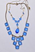 TWO BLUE PASTE SET NECKLACES, the first set with square blue paste on a brass toned curb link chain,