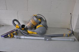 A DYSON DC05 PULL ALONG VACUUM CLEANER with various attachments (PAT fail due to uninsulated plug