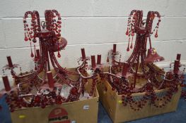 TWO MODERN RED FINISH CHANDELIERS with glass droppers and five matching twin branch wall lights (