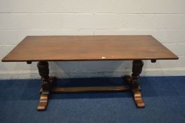 A GOOD QUALITY REPRODUCTION OAK RECTANGULAR REFECTORY TABLE, on twin acorn supports, united by a