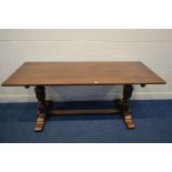 A GOOD QUALITY REPRODUCTION OAK RECTANGULAR REFECTORY TABLE, on twin acorn supports, united by a