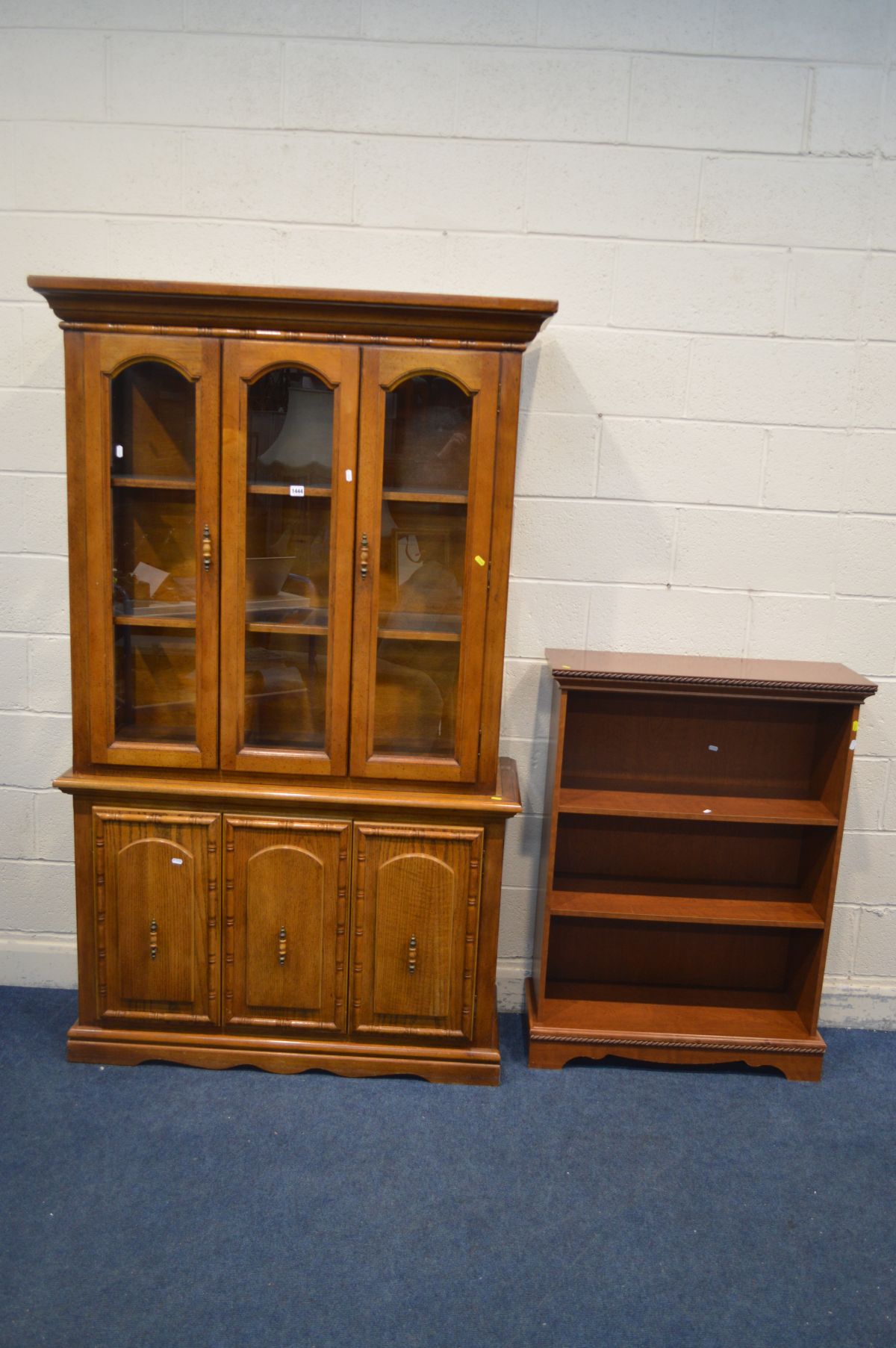 A HARDWOOD GLAZED DOUBLE DOOR BOOKCASE, width 120cm x depth 43cm x height 198cm and a cherrywood