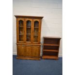 A HARDWOOD GLAZED DOUBLE DOOR BOOKCASE, width 120cm x depth 43cm x height 198cm and a cherrywood