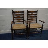 A PAIR OF 20TH CENTURY GEORGIAN STYLE ELM AND OAK LADDERBACK ELBOW CHAIRS with rush seats