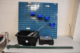 A WORKSHOP WALL MOUNTED TOOL RACK with four tubs, a tray of four grease guns, a boxed set of