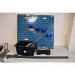 A WORKSHOP WALL MOUNTED TOOL RACK with four tubs, a tray of four grease guns, a boxed set of