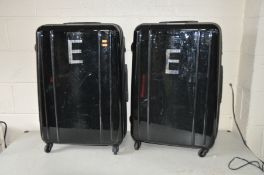 A PAIR OF HARDSHELL SUITCASES 77cm high 48cm wide and 31cm deep with four wheels to each