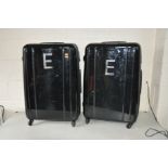 A PAIR OF HARDSHELL SUITCASES 77cm high 48cm wide and 31cm deep with four wheels to each