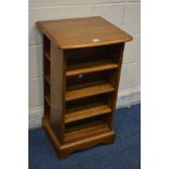 AN ERCOL GOLDEN DAWN ELM OPEN BOOKCASE, with side shelves, width 44cm x depth 39cm x height 79cm