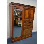 AN EDWARDIAN WALNUT COMPACTUM WARDROBE, with a single mirror door and six drawers, width 195cm x