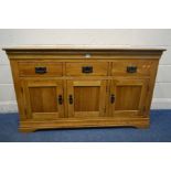A SOLID GOLDEN OAK SIDEBOARD with three drawers, width 139cm x depth 43cm x height 83cm (good