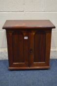 A LATE 19TH/EARLY 20TH CENTURY WALNUT PANELLED TWO DOOR CABINET, with the door enclosing an