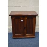 A LATE 19TH/EARLY 20TH CENTURY WALNUT PANELLED TWO DOOR CABINET, with the door enclosing an