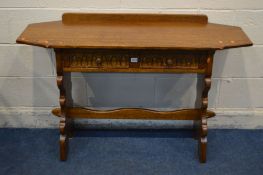 AN OAK HALL TABLE with canted ends, two frieze drawers on twin shaped supports united by a