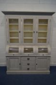 A LARGE TRIPLE DOOR GLAZED BOOKCASE, painted in Annie Sloan paint, with three central domed doors,