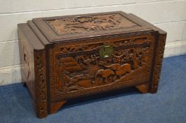 AN ORIENTAL CARVED CAMPHORWOOD BLANKET CHEST, with an internal tray, width 105cm x depth 55cm x