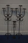 A PAIR OF WROUGHT IRON TRIPLE BRANCH CANDLE STANDS with another similar candle stand (3)