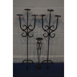 A PAIR OF WROUGHT IRON TRIPLE BRANCH CANDLE STANDS with another similar candle stand (3)