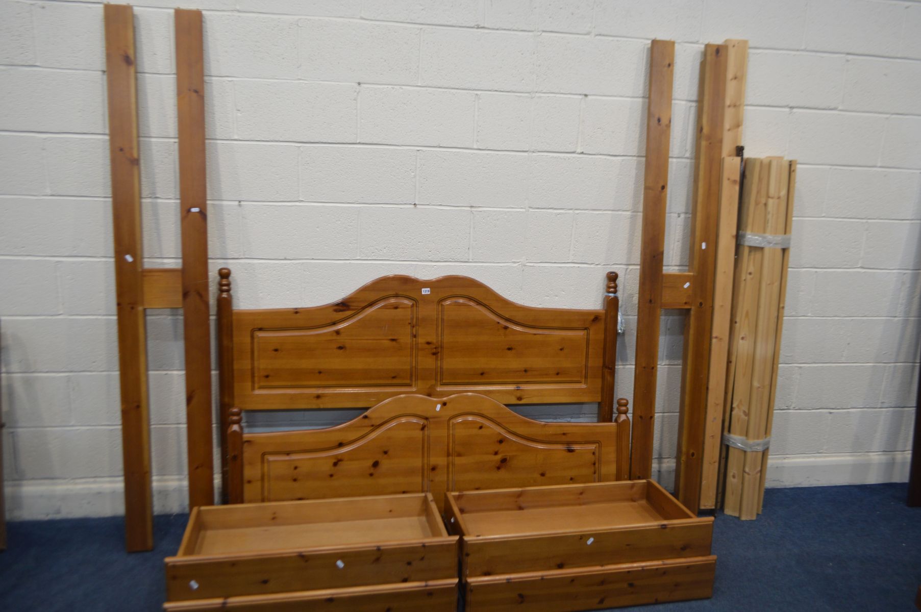 A PINE 5FT BEDSTEAD with side rails containing two drawers each, slats and bolts