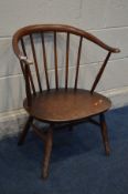 A DARK ERCOL ELM AND BEECH MODEL 449A COWHORN AMRCHAIR (worn finish, solid frame)